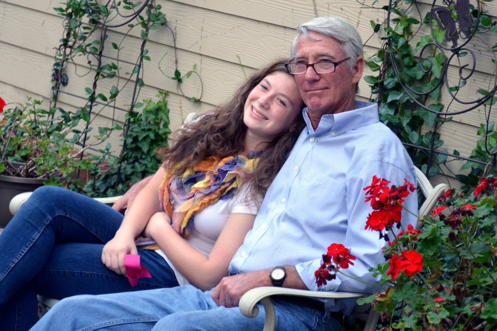 Grandy snuggles his oldest granddaughter, Samantha.