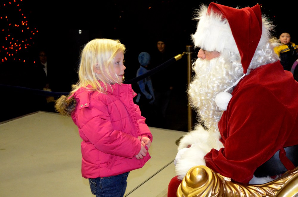 Heidi wanted no part of sitting on Santa's lap.  Like most kids, she has no issue telling me what she wants to have but only had one request for Santa on this night..."things to hang in my Mommy's ears."  It was the sweetest thing!  Santa came through on Christmas, FYI.
