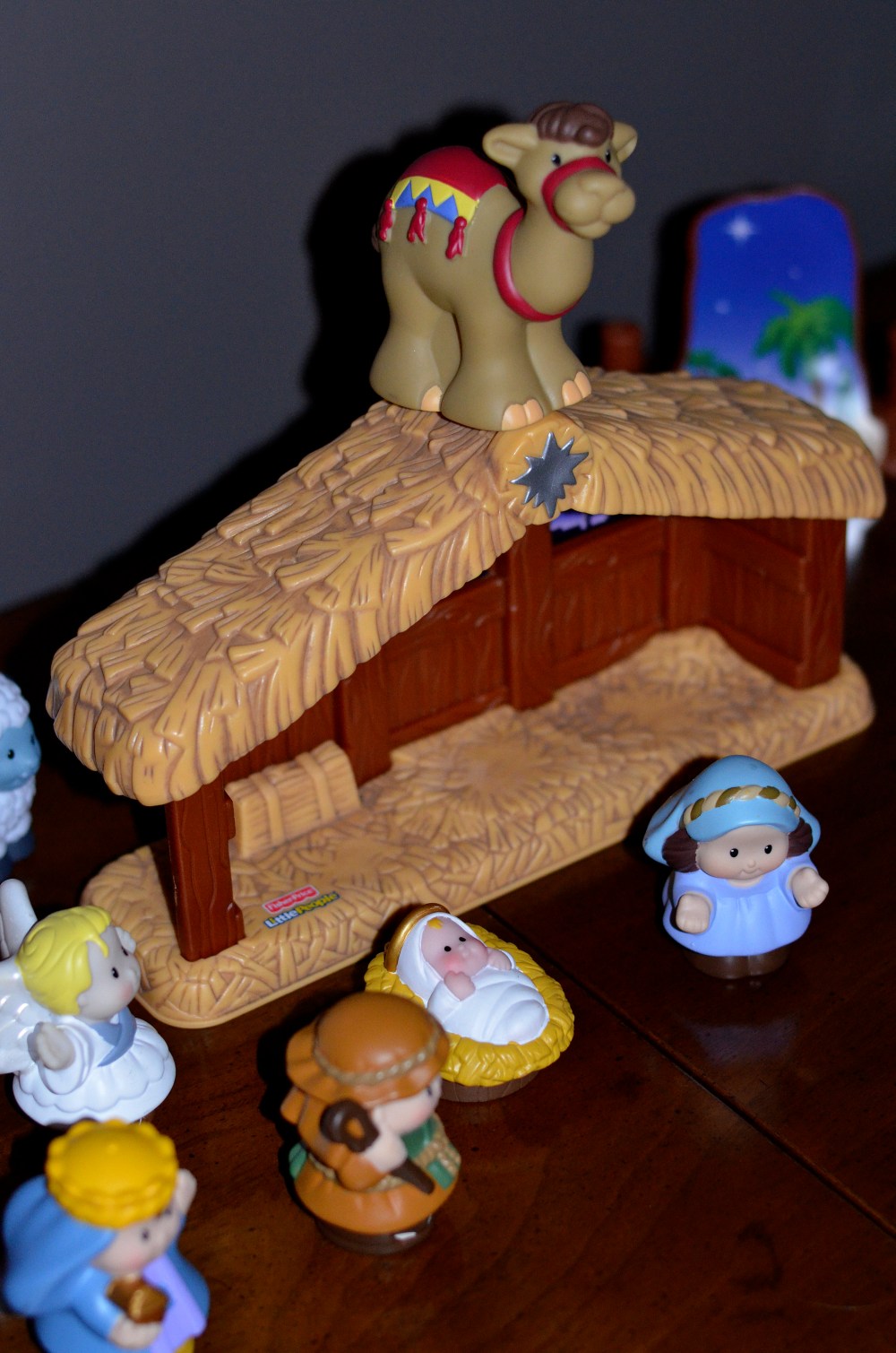 We have a very special heirloom nativity that Michael's father made and this one that I let the kids set up and play with each year.  I am sure the angel cares not where in the nativity it is as long as it is near Jesus.  I'm sure that camel is not much on his position though.