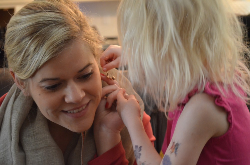 Heidi helps Miss Catherine put on her new earrings.