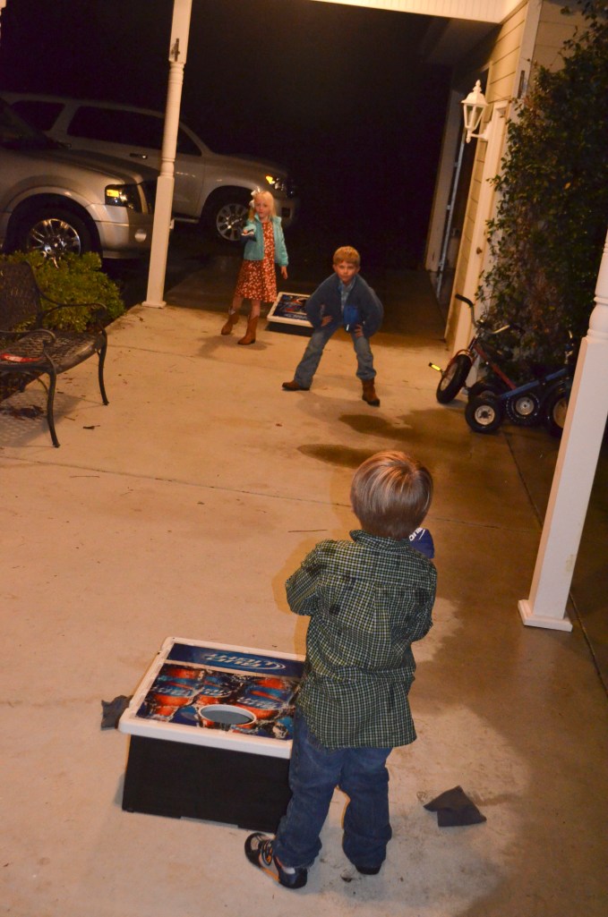 Littles playing a little cornhole